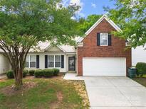 Charming home with well-manicured lawn, featuring a blend of brick and siding and a one-car garage at 4510 Glenlea Commons Dr, Charlotte, NC 28216