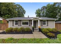 Charming brick home with well-maintained landscaping and a welcoming entrance with dark shutters at 5008 Unaka Ave, Charlotte, NC 28205