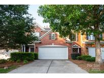 Charming brick home with mature trees, a two-car garage and a well-maintained lawn at 10433 Blairbeth St, Charlotte, NC 28277
