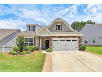 Charming single-Gathering home featuring a two-car garage and manicured landscaping at 209 Van Gogh Trl, Mount Holly, NC 28120