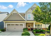 Charming two-story home featuring a manicured lawn, covered porch, and an attached two-car garage at 2246 Bluebell Way, Fort Mill, SC 29708
