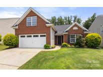 Charming brick home with a well-manicured lawn and attached two-car garage at 2448 Sweet Birch Ct, Gastonia, NC 28054