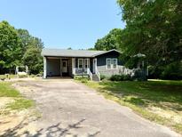 Charming single-story home with a covered front porch and gray siding on a sunny day at 3810 Biggers Rd, York, SC 29745