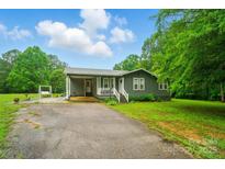 Charming single-story home with a well-maintained lawn, cozy front porch, and convenient covered parking at 3810 Biggers Rd, York, SC 29745