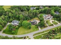 Expansive aerial view of multiple homes nestled within a lush, green, and wooded landscape at 5916 Cashion Rd, Huntersville, NC 28078
