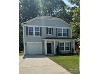Charming two-story home with grey siding, a well-maintained lawn, and an attached one car garage at 672 Carybrook Ct, York, SC 29745