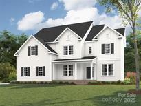 Stunning new construction featuring a classic white exterior, black shutters, and covered front porch at 11009 Tyler Brook Ln # Oak0043, Mint Hill, NC 28227