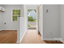 Bright foyer with wood-look flooring, white walls, window and view of the neighborhood at 1231 Maple Shade Ln, Charlotte, NC 28270