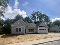 Charming single-story home with white siding, attached garage, and freshly mulched front yard at 1312 W Monroe Rd, Salisbury, NC 28144