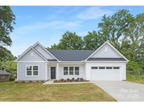 Charming single-Gathering home featuring a two-car garage and manicured front lawn with beautiful landscaping at 1312 W Monroe Rd, Salisbury, NC 28144