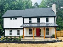 Charming two-story home with a welcoming front porch and a striking red front door at 136 Digh Cir # 4, Mooresville, NC 28117