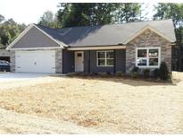 Charming single-story home featuring a gray exterior, stone accents, and a two-car garage in a suburban setting at 1802 Cooper Ave, Kannapolis, NC 28081