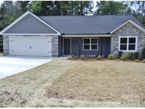 Charming home featuring stone accents, grey siding, and a neatly maintained front yard at 1802 Cooper Ave, Kannapolis, NC 28081