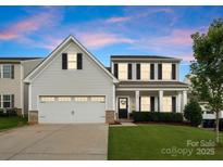 Charming two-story home with a well-manicured lawn and attached two-car garage at 204 Fesperman Cir, Troutman, NC 28166