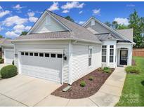 Charming home featuring a two-car garage, manicured landscaping, and inviting front entrance at 21214 W Tern Ct, Fort Mill, SC 29707