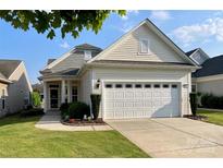 Charming single-story home featuring a two-car garage, well-maintained lawn, and inviting front entrance at 23117 Whimbrel Cir, Fort Mill, SC 29707