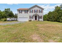 Charming two-story home with vinyl siding, brown shutters, attached garage, and a large lawn at 3401 Shillinglaw Rd, Sharon, SC 29742