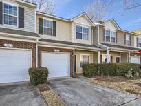 Charming townhouse with a one car garage, brick accents, and manicured landscaping at 463 Delta Dr, Fort Mill, SC 29715