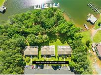 Stunning aerial view of townhomes, lake access, and boat docks surrounded by lush greenery at 49009 Dockside Ln # D, Albemarle, NC 28001