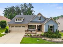 Charming home with a well-manicured lawn and a cozy front porch with stone accents at 708 Ardent Trl, Belmont, NC 28012