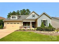 Charming two-story home featuring a landscaped front yard, inviting porch, and attached two car garage at 708 Ardent Trl, Belmont, NC 28012