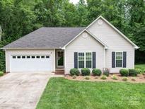 Charming single-story home featuring a well-manicured lawn and an attached two-car garage at 727 Cove Rd, Gastonia, NC 28052