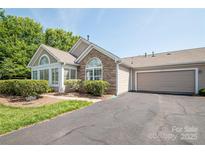 Charming single Gathering home featuring a one car garage and stone facade at 8183 Sultana Cir, Charlotte, NC 28227