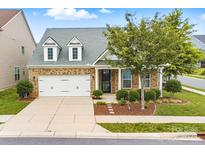 Charming brick home with a manicured lawn, two-car garage, and inviting curb appeal at 867 Pecan Tree Ln, Fort Mill, SC 29715
