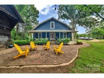 Backyard patio with chairs, ideal for outdoor entertaining and relaxation at 9929 Kerns Rd, Huntersville, NC 28078