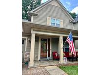 Charming front porch with patriotic decor, cozy seating, and inviting entrance at 128 Aztec Cir, Mooresville, NC 28117