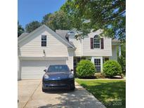 Charming two-story home with a garage, landscaped yard, and a well-maintained driveway at 13039 Peacock Ln, Charlotte, NC 28215