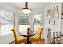 Bright breakfast nook features sun-filled windows, hardwood floors, and charming yellow chairs at 1530 Danlee Dr, Lancaster, SC 29720