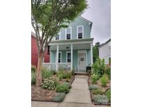 Charming two-story home with a welcoming front porch, beautiful landscaping, and a well-maintained walkway at 15907 Rose Glenn Ln, Davidson, NC 28036