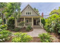 Charming home featuring a cozy front porch, a landscaped yard, and a welcoming entrance at 1701 Truman Rd, Charlotte, NC 28205