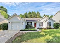 Charming home with a well-maintained front yard, lush green grass, and a welcoming red door at 1922 Decatur Ct, Charlotte, NC 28213