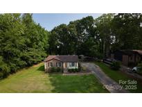 Charming single-story home with a brick facade and a well-manicured lawn at 214 Cottage Pl, York, SC 29745