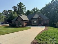 Charming brick home with manicured lawn and inviting driveway at 2341 Shiny Leaf Dr, Denver, NC 28037
