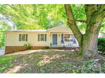 Charming single-story home with a covered front porch and well-maintained landscaping beneath the shade of mature trees at 3043 Charles Rd, Shelby, NC 28152