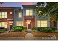 Beautiful brick townhome with manicured landscaping and a serene setting during twilight at 3153 Bending Birch Pl, Charlotte, NC 28206