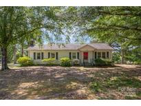 Charming single-story home with a well-maintained front yard and mature trees offering ample shade at 3595 Mt Holly Rd, Edgemoor, SC 29712