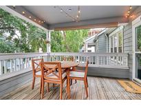 Charming outdoor patio area with wooden table and string lights, perfect for relaxing and entertaining guests at 433 W 8Th St # 66, Charlotte, NC 28202