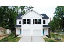 Beautiful new construction duplex featuring a bright white facade and garage at 619 Billingsley Rd, Charlotte, NC 28211