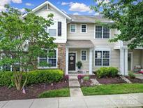 Charming townhome featuring a welcoming facade, well-manicured landscaping, and inviting entrance with stylish decor at 635 Brickdust Ct, Fort Mill, SC 29708