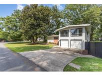 Charming two-story home with a two car garage and lush greenery in the front yard at 747 Saint Michaels Ln # 7, Gastonia, NC 28052