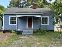 Charming single-story home featuring a covered entry, quaint front yard, and classic architectural details at 839 S Chester St, Gastonia, NC 28052