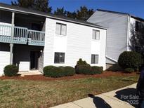Well-maintained, two-story condo with tidy landscaping and covered balcony at 11010 Harrowfield Rd, Charlotte, NC 28226