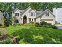 Charming two-story home with a well-manicured lawn and lush landscaping at 12712 Hollyhock Ln, Huntersville, NC 28078