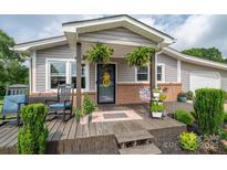 Charming front porch with rocking chair, lovely plants, and welcoming decor on this inviting home at 2206 Whitworth Rd, Cherryville, NC 28021