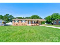 Charming brick home with a well-maintained lawn and covered carport at 3413 Fallston Rd, Shelby, NC 28150
