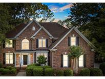 Charming brick two-story home featuring a well-manicured lawn and classic architectural details at 5310 Addington Ct, Charlotte, NC 28277